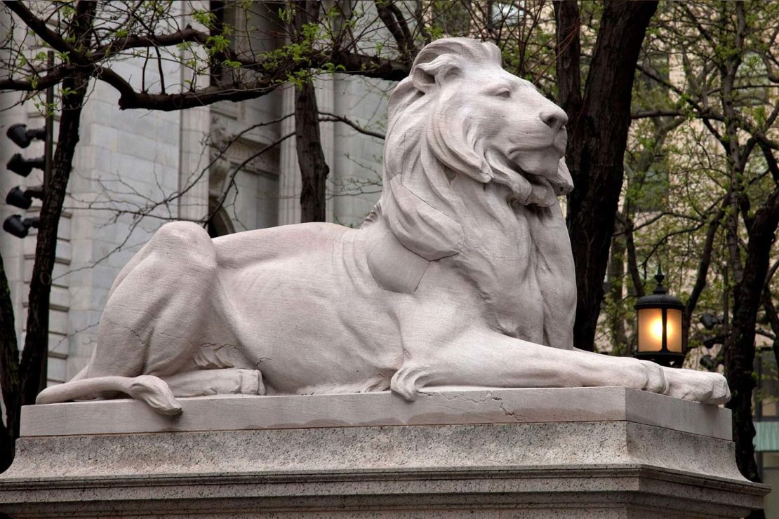 A lion statue guards the Fifth Avenue entrance to the library